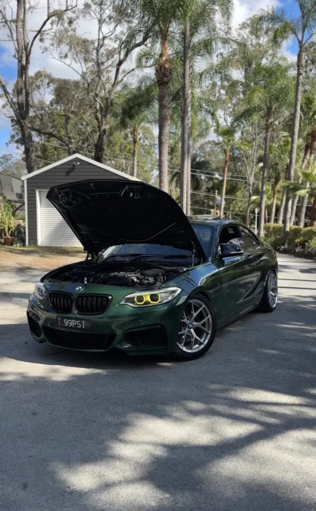 Josh's green BMW 240i (@99psi_) with the bonnet up, running EuroSpec parts